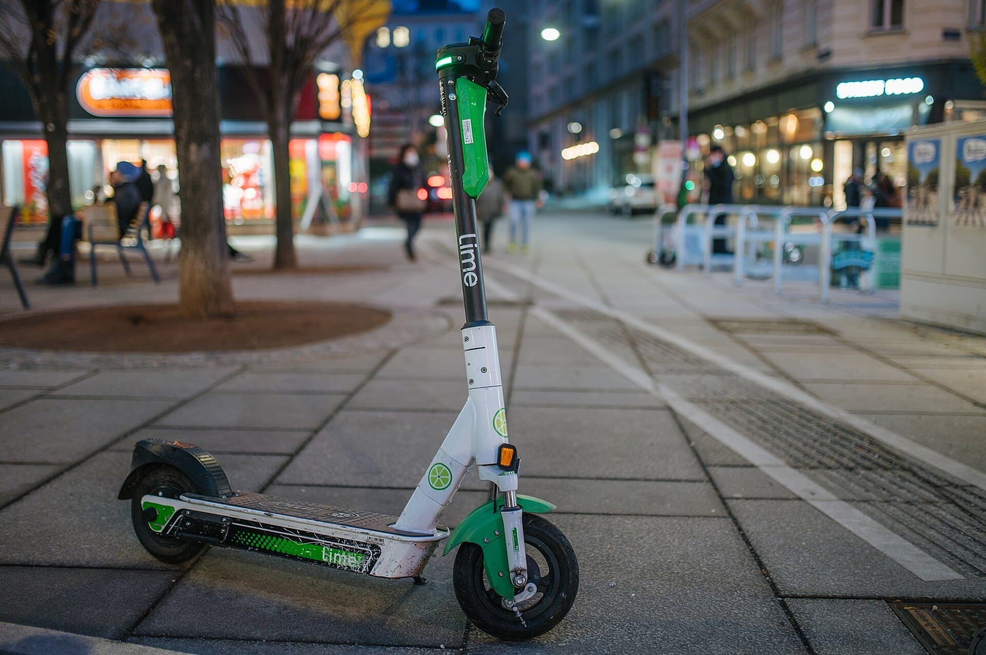 Electric kick scooter parked on a city sidewalk