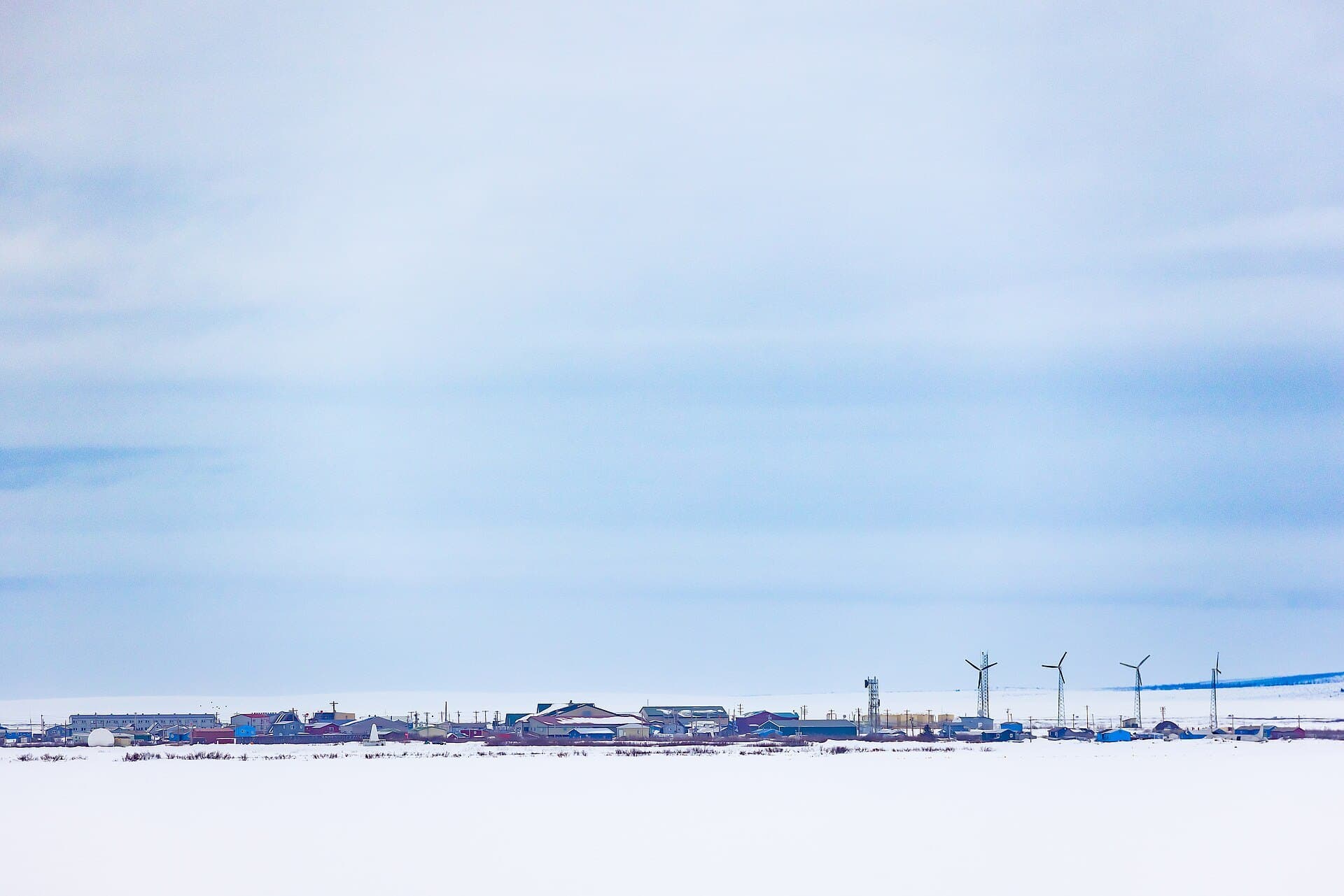 Houses and wind turbines on the snowy tundra at Selawik, Alaska, near Selawik National Wildlife Refuge (USFWS photo by Lisa Hupp)