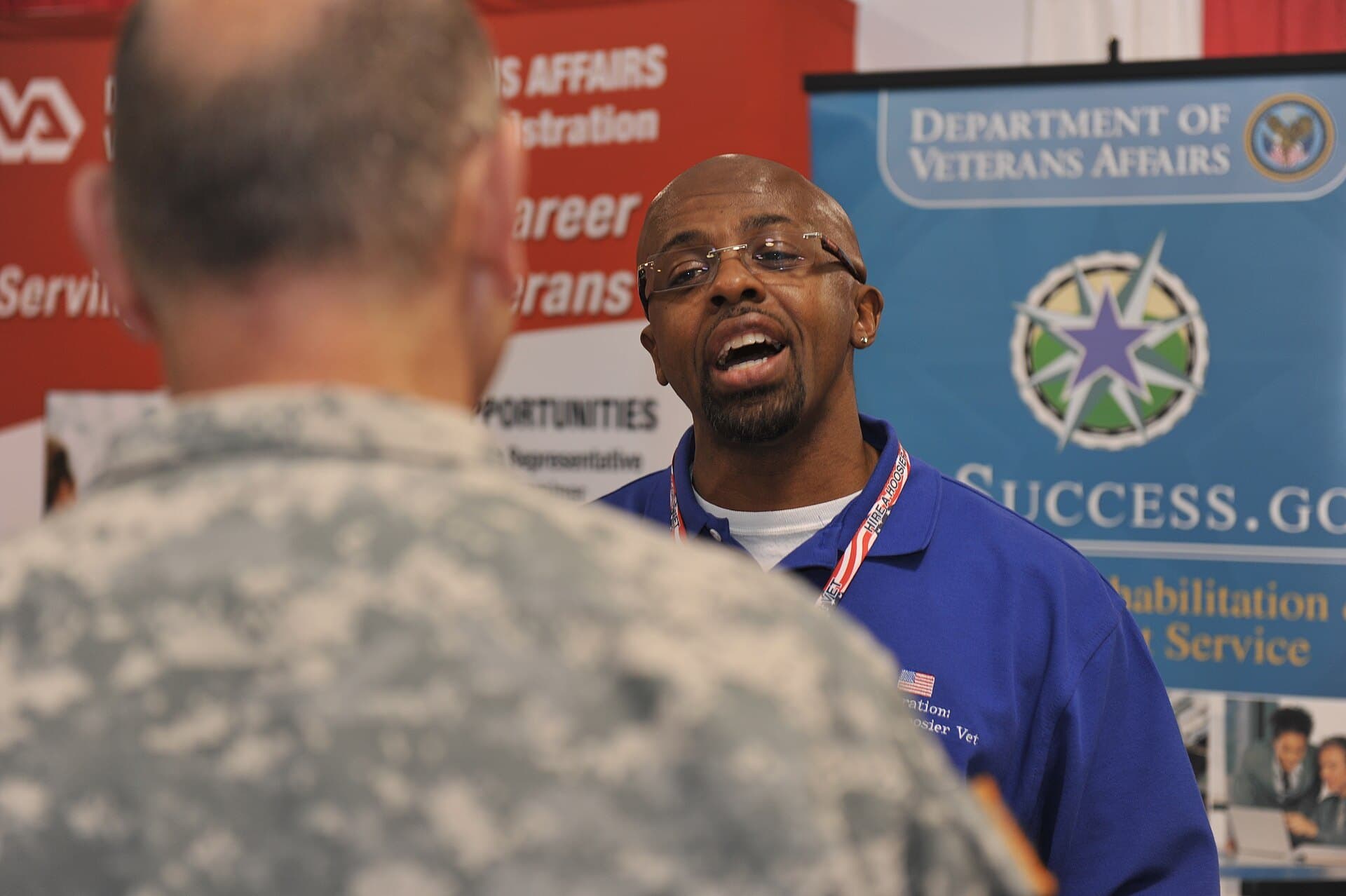A Department of Veterans Affairs employment coordinator talks with a service member at the Operation Hire a Hoosier Vet Job Fair, Indiana State Fairgrounds, April 2013 (Indiana National Guard photo)