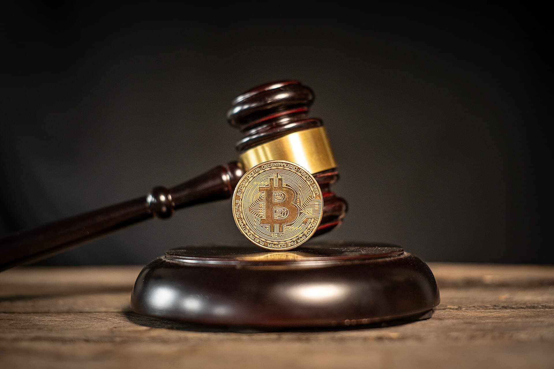 A Bitcoin medallion resting on a judge’s gavel, illustrating cryptocurrency regulation