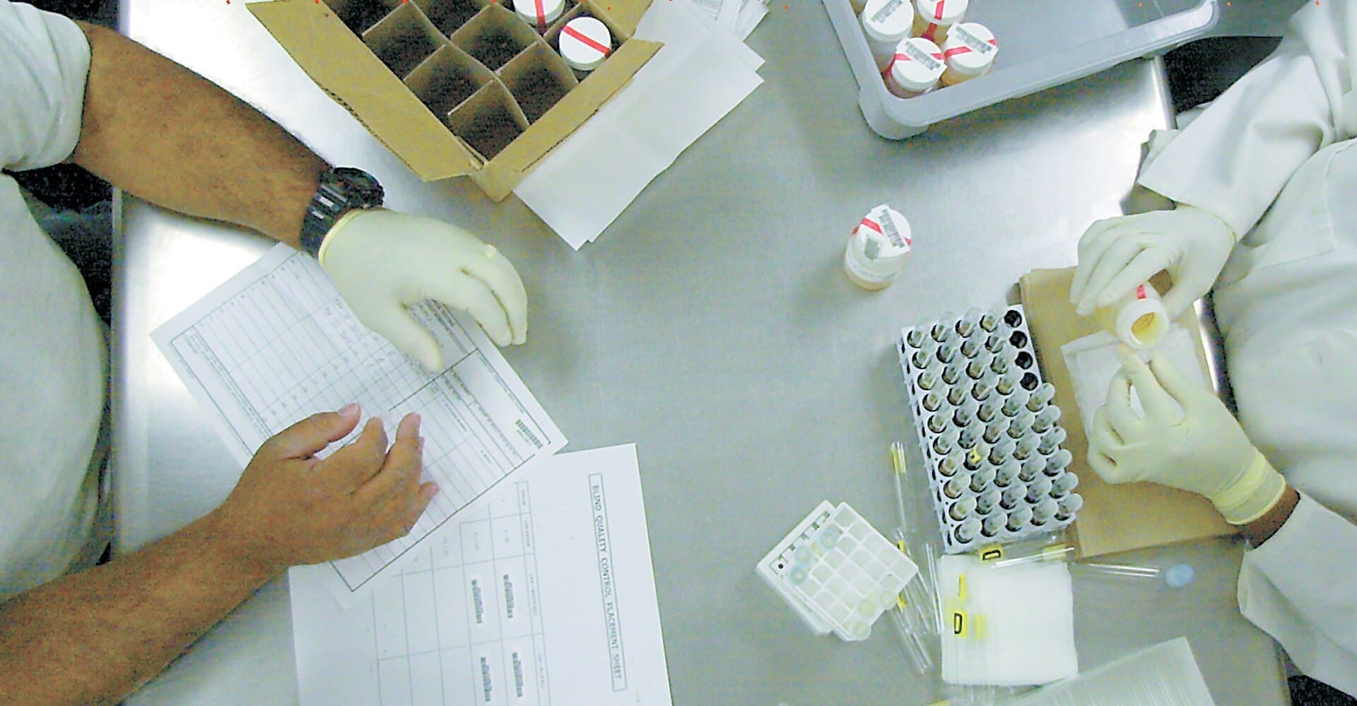 Technician preparing urine samples at a drug-screening laboratory
