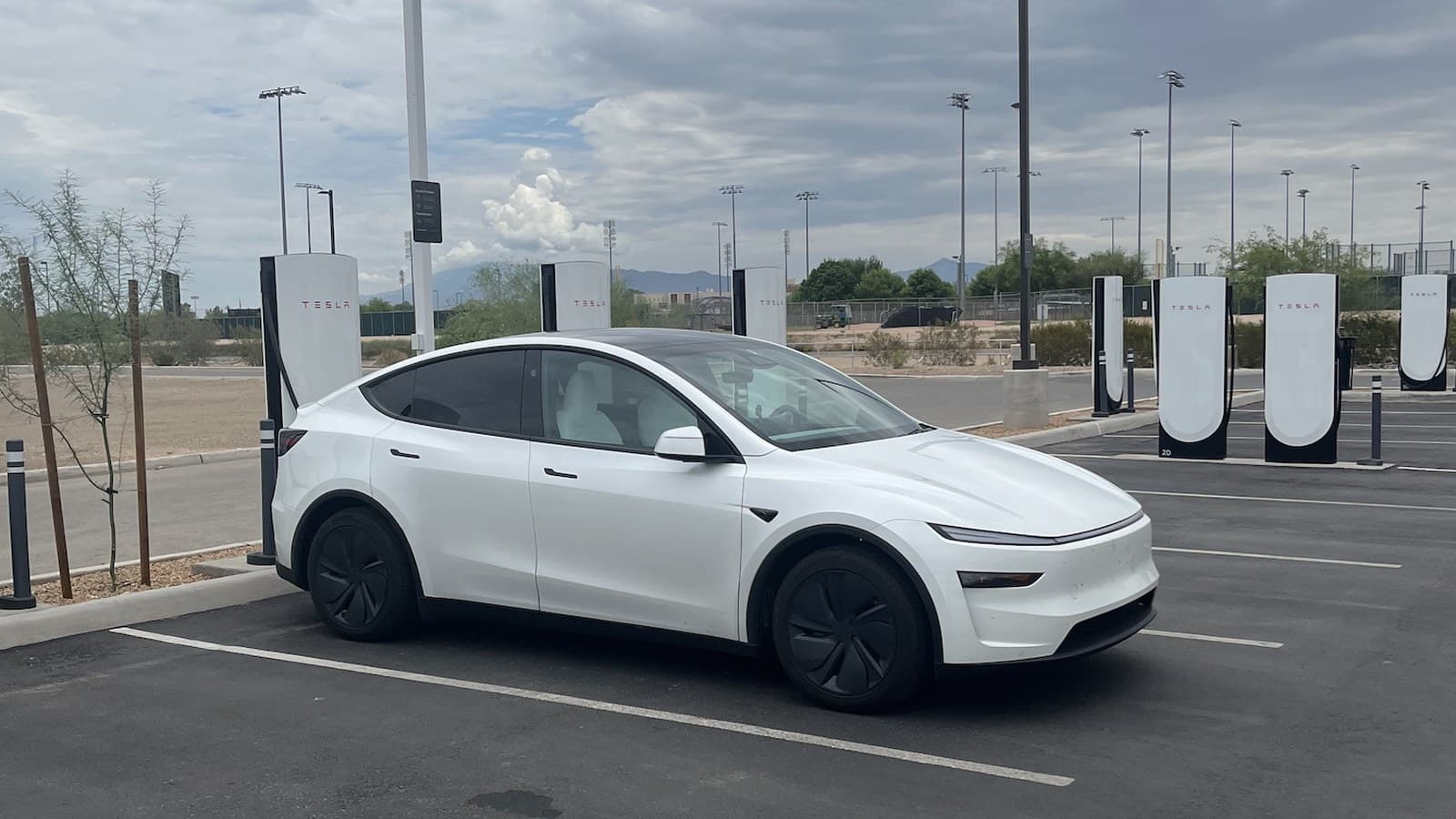 Arizona Department of Transportation photo of a white electric vehicle parked at a fast-charging station