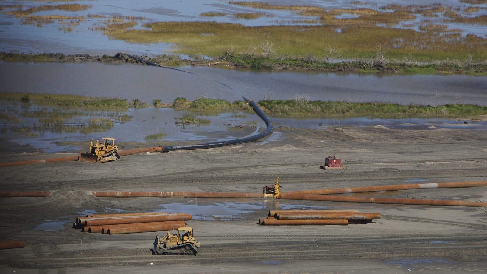 Pipelines and bulldozers place dredged sediment to rebuild coastal marsh in Louisiana after Hurricane Katrina (file photo, illustrative; not the East Orleans Landbridge or Raccoon Island projects).