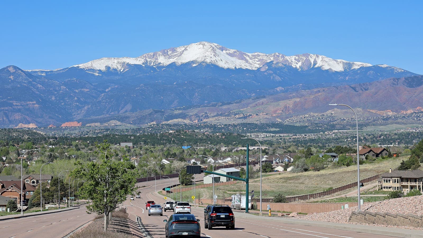 Pikes Peak and northern Colorado Springs seen from East Woodmen Road, El Paso County, Colorado (file photo, illustrative; not the Bent Grass site).