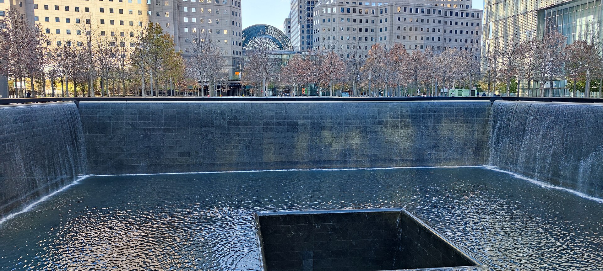 A reflecting pool at the National September 11 Memorial in New York, water falling into the footprint of a fallen tower